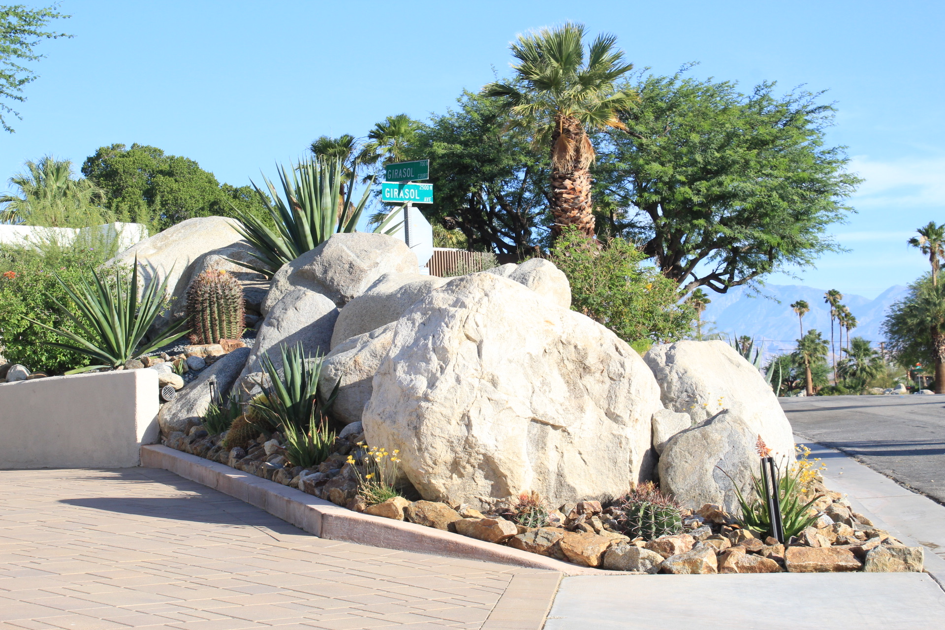Desert landscaping with natural boulders and agave