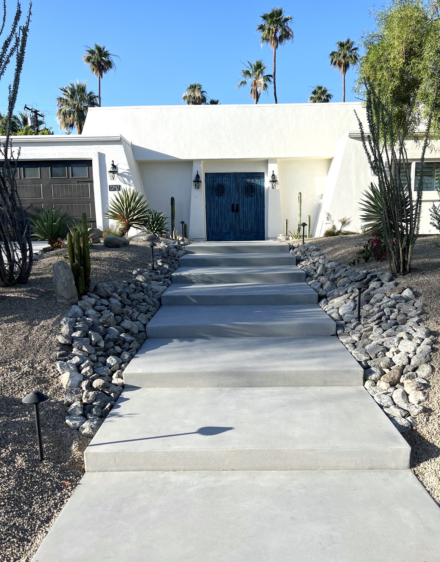 Front entrance walkway bordered by desert plants and river rocks